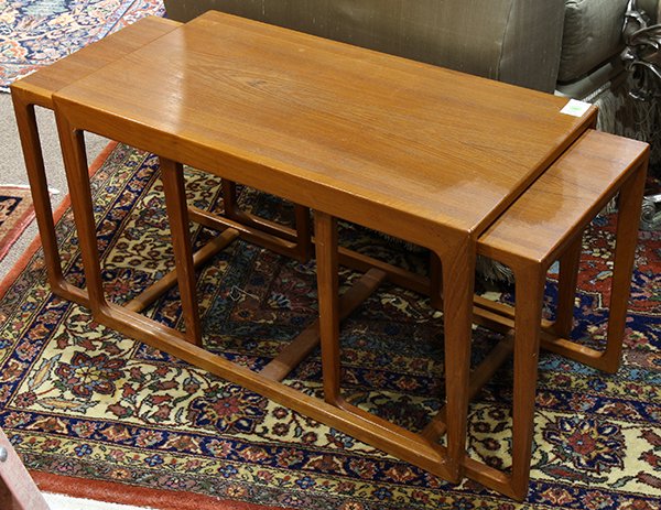 (Lot of 3) Danish Mid Century Modern nesting tables: (Lot of 3) Danish Mid Century Modern nesting tables, executed in teak, each having a rectangular top above tapered legs conjoined by an H-form stretcher, largest; 18"h x 29"w x 15.5"d