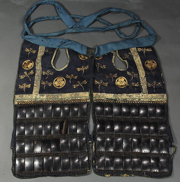 Japanese Armor Chest Cover, 18c: Japanese armor chest cover, Edo period, fabric and iron plates, fabric decorated with dragonflies and family crests on blue ground (disintegrating), approx. 21.5"l x 23"w; Provenance: Property from a 