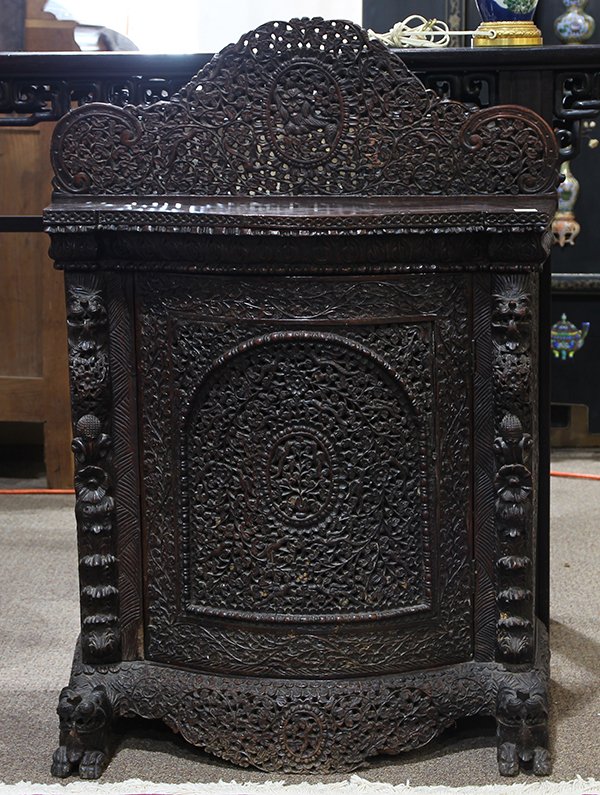 Anglo-Indian Carved Side-Server: Anglo-Indian wooden side-server, the concaved hinged door elaborately reticulated with birds and flowers, the apron decorated en suite and raised on lion form supports, the back splash centered with a