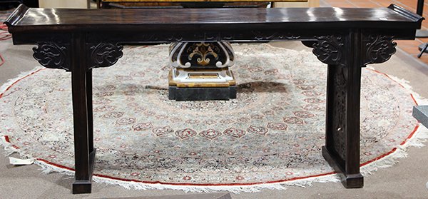 Chinese Hardwood Altar Table: Chinese hardwood altar table, with a single board top with up turned flanges, the apron carved gui-dragon and scrolls, the side panel reticulated with dragons and ruyi, 35.5"h x 79.75"w x 15.75"d