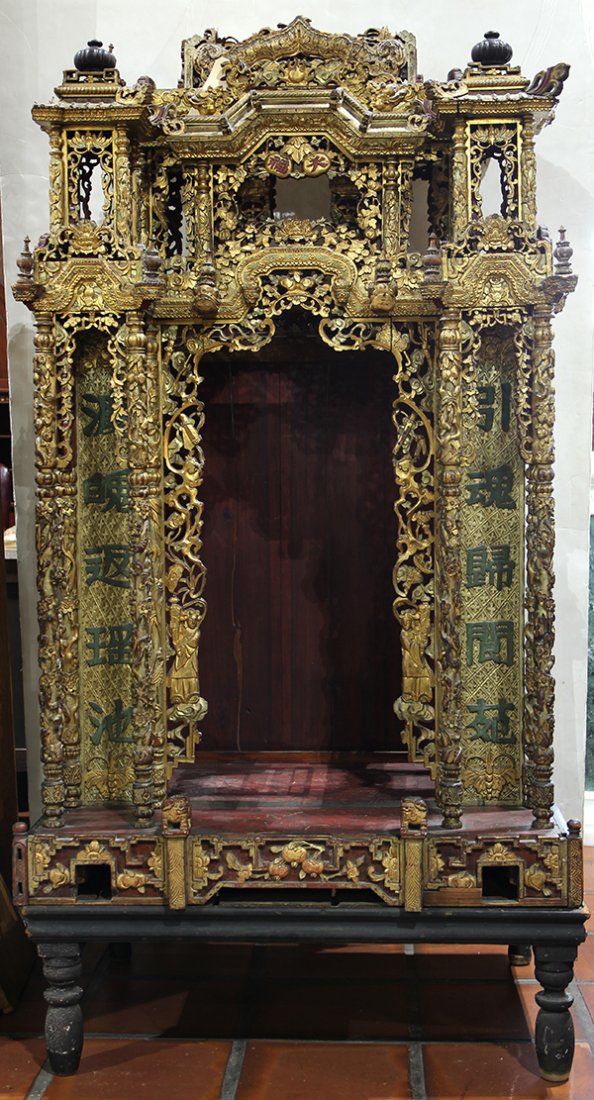 Chinese Gilt Lacquer Wood Shrine: Chinese gilt lacquered wood altar, the central niche framed by pierced attendants, treasures and tendrils, flanking a pair of colophon and fronted by columns carved with birds and flowers, and surmoun