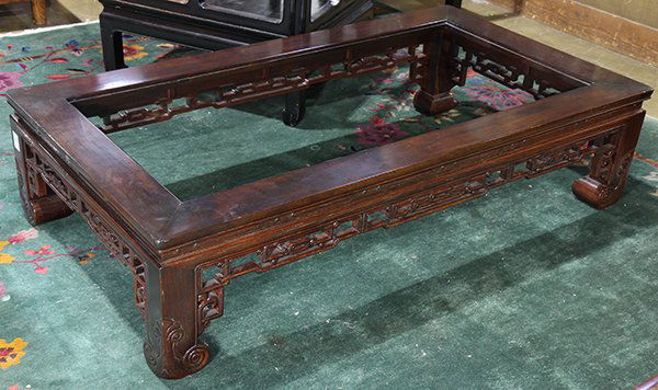 Chinese Hardwood Low Table: Chinese hardwood low table, with an openwork scroll apron, raised on short supports with scrolling terminals, 14"h x 58.75"w x 32"d (missing glass)