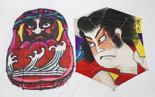 Japanese Kites, Indonesian Shadow Puppets: (lot of 10) Seven Japanese kites: in the form of a fugu (blowfish), a foot-soldier, Kabuki Ranmaru, Daruma, a crane, and two with samurai family crests; together with three Indonesian Javanese traditi