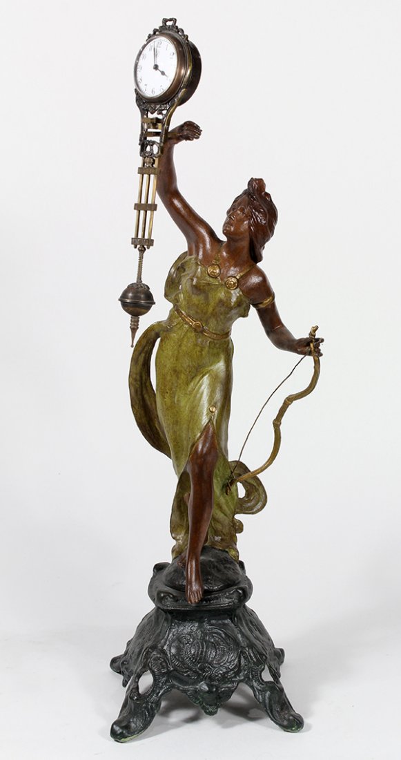 Art Nouveau patinated metal swinger clock: Art Nouveau patinated metal swinger clock, having an Arabic numeral dial, the weighted clock balanced on a figural base depicting a beauty, 22.5"h