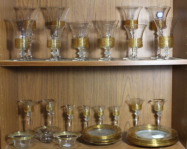 (lot of 32) Moderne art glass stemware group: (lot of 32) Moderne art glass stemware group, in clear glass with bubble inclusions, the bowl decorated with applied stringing in gold, consisting of (4) red wines; (4) white wines; (4) water goblets;