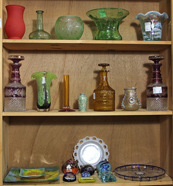 (lot of 24) Three shelves of glass and crystal: (lot of 24) Three shelves of glass and crystal decorative items, including an English cut glass vase with trailing lotuses and lily pads, executed in emerald glass, marked, a Fenton hand painted vase 