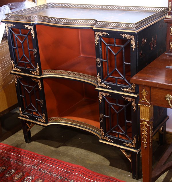 Chinese style gilt and ebonized bookcase, having a: Chinese style gilt and ebonized bookcase, having a gallery top, decorated with figures in a landscape on an ebonized ground, surmounting the two door case with four pierced doors, and rising on square
