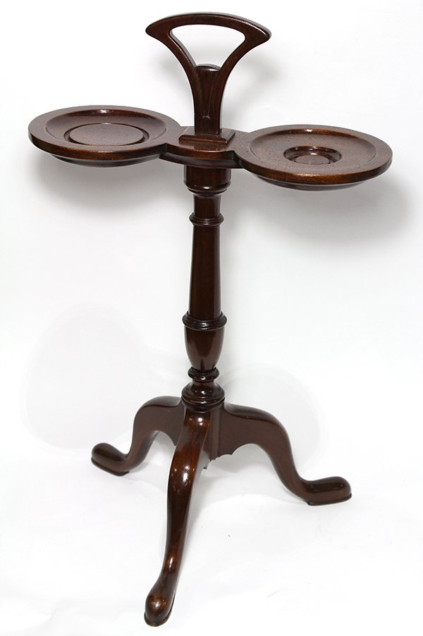 English mahogany biscuit stand, having a handle flanked: English mahogany biscuit stand, having a handle flanked with two circular trays, above a turned standard, rising on a tripod base, 22"h. Provenance: From the Pittsburgh, PA estate of Richard Mellon Sc