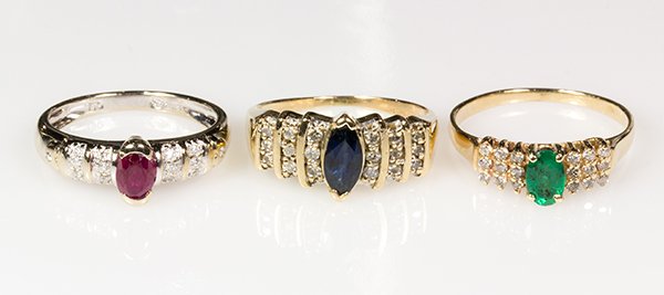 (Lot of 3) Gemstone and gold rings: (Lot of 3) Gemstone and gold rings comprised of one 18k white gold ring set with an oval cut ruby and full cut diamonds, size 6 3/4, weighs 3.1 grams; one emerald, diamond and 14k yellow gold ring, si