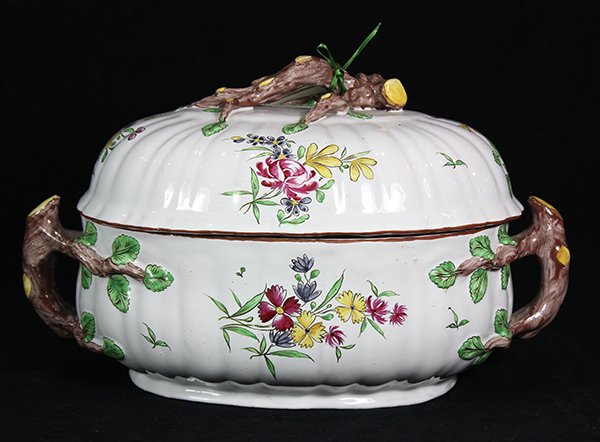 French faience tureen by Luneville, 18th century, the: French faience tureen by Luneville, 18th century, the lid with branch form handle and hand painted floral sprays surmounting the conforming base with naturalistic branch handles and centering floral r