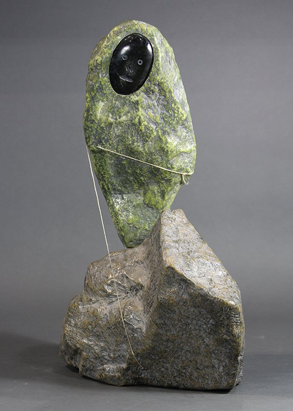 Matiusie Iyaituk (1950- ): Matiusie Iyaituk (1950- ), Inuit figural sculpture in serpentine and caribou sinew, titled "Not Knowing What Kind of Fish She is Catching from the Deep Lake", signed underside (archive retains Candian