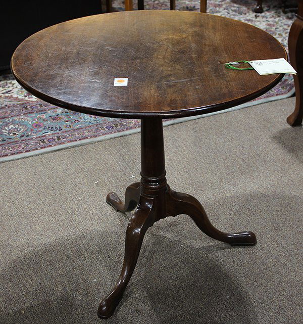 George III tilt top mahogany tea table, circa 1780,: George III tilt top mahogany tea table, circa 1780, having a circular top, surmounting the turned standard, and rising on a tripod base terminating on snake feet, 28"h; Provenance: Thomas Livingston A