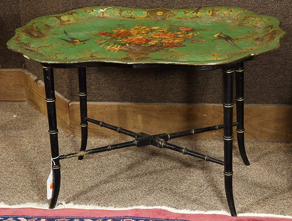 Victorian papier-mache tray on stand, having a gilt: Victorian papier-mache tray on stand, having a gilt border with foliate and scrolled decoration, centering a floral bouquet flanked by exotic birds on a green ground, rising on a later ebonized stand 
