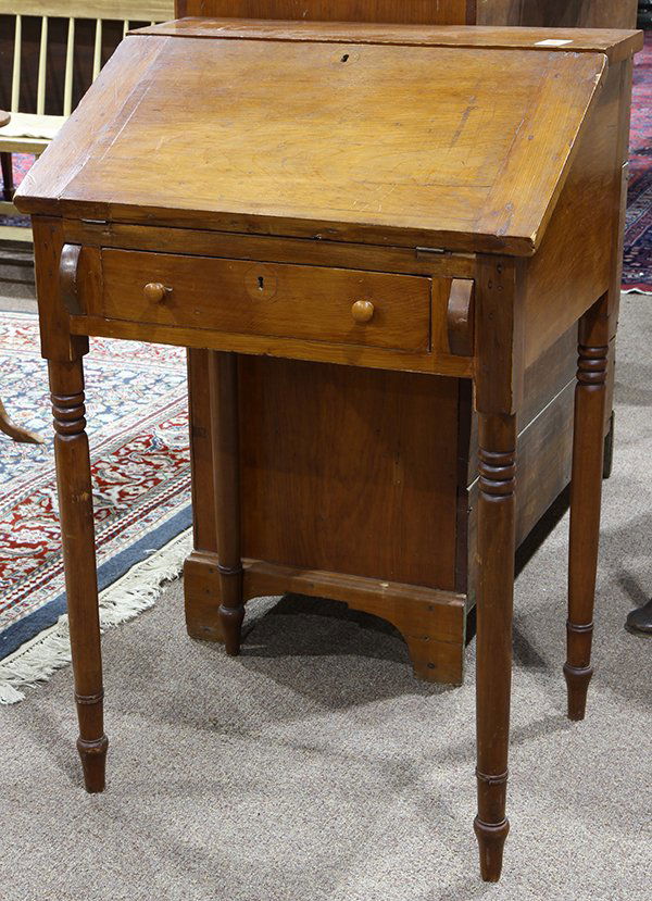American Primitive drop front writing desk, second half: American Primitive drop front writing desk, second half 19th century, the slant front opening to the fitted interior, surmounting the single drawer case, and rising on turned legs, 39"h x 26"w x 20"d;