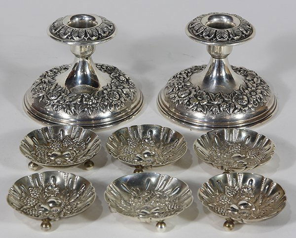 S.Kirk & Son sterling silver repousse table: (lot of 8) S.Kirk & Son sterling silver table accessories consisting of a pair floral repousse deocorated low candle holders with weighted bases; together with six footed nut dishes decorated with rep