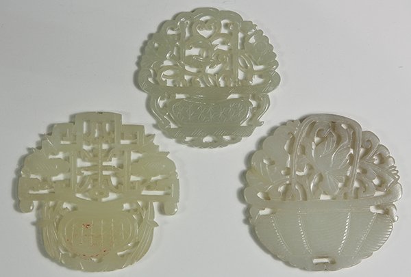 Three Chinese Jade Plaques, Flower Baskets: (lot of 3) Chinese pierced jade plaques, each in the form of flower baskets, including one centered by the character 'shou' (longevity), largest: 2.25"h. Provenance: collection of Mrs. Ellen Sutton, I