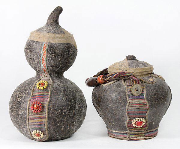 Two Tea Containers: (lot of 2) Chinese tea containers, one with a tapering body with the characters 'fu' and 'cha' (tea), with a rope handle; the other of double gourd form, with the characters 'cai yunnan' above a round