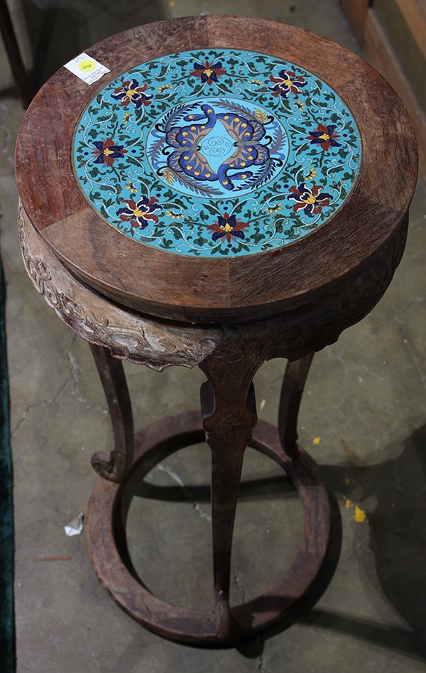 Chinese Cloisonne and Wood Stand: Chinese wooden flower stand with cloisonne plaque, the top inlaid with a cloisonne panel centered with butterflies surrounded by lotus on a turquoise ground, the apron carved with dragons, raised on c