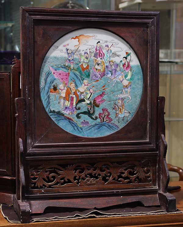 Chinese Famille Rose Porcelain Plaque: Chinese famille rose porcelain plaque, set as a table screen, featuring the Eight Daoist Immortals crossing the sea, with wood frame and stand, plaque: 16.75"h, overall (with stand): 24"h