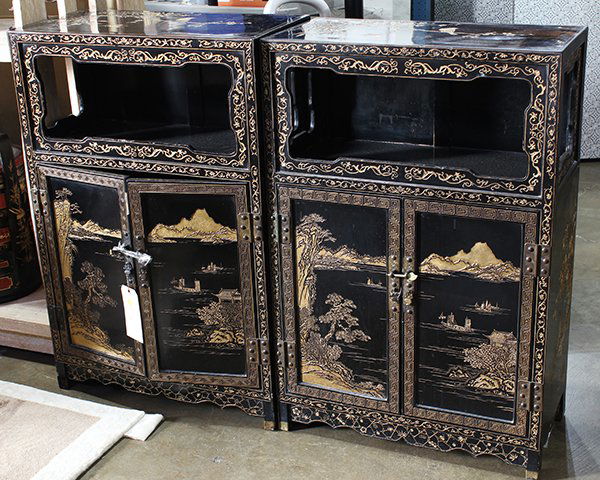 Two Chinese Small Gilt Lacquer Cabinets: (lot of 2) Chinese gilt black lacquer side cabinets, with an open shelf above hinged double doors carved with a landscape scene, the top decorated with a warbler on a prunus branch, 36"h x 24.25"w x 1
