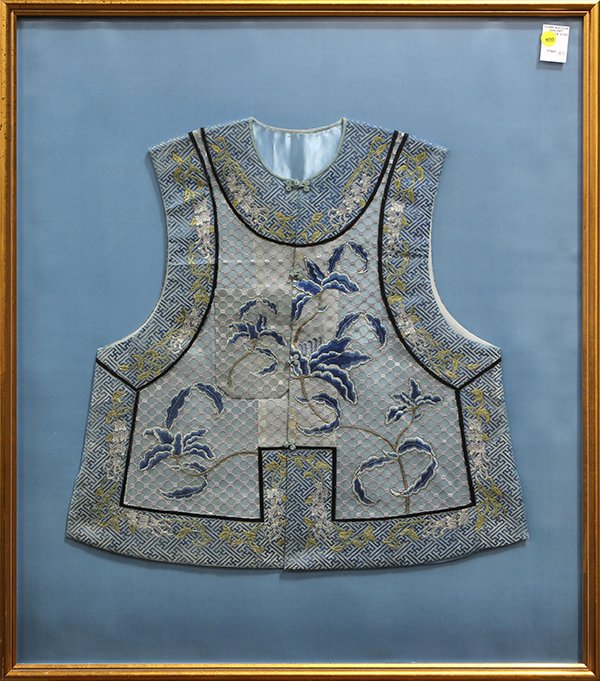 Framed Chinese Lady's Vest: Framed Chinese lady's blue vest, embroidered with blue flowering leafy branches on a gauze ground, wanzi pattern to the rim, 33"h × 29"w