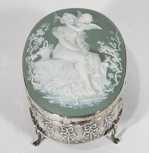 Neo-Classical trinket box: Neo-Classical trinket box, the English sterling silver stand decorated with swags and bows raised on cabriole legs, the hinged cover having a bisque green inset plaque classically decorated, 3"h x 5"l