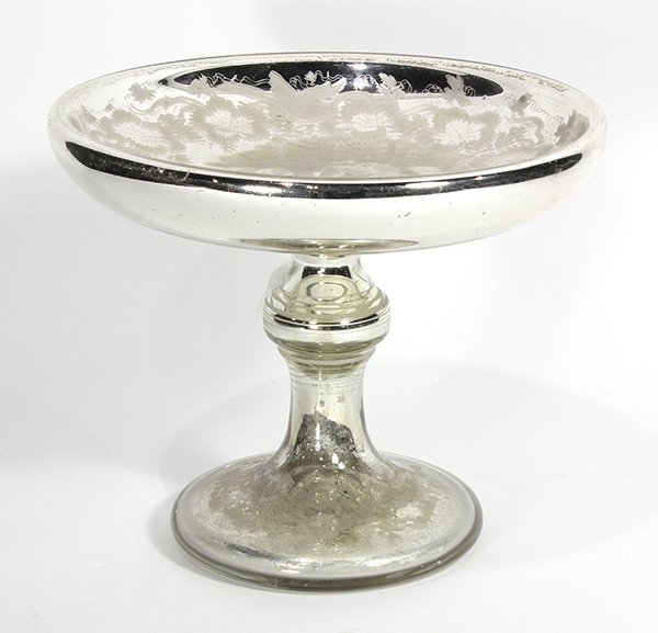 Mercury glass compote, having an etched floral band: Mercury glass compote, having an etched floral band with birds and centering a star, rising on a baluster standard, and resting on a circular foot, 9.5"h x 11"dia. Provenance: From the Pittsburgh, PA 