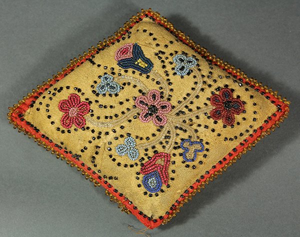 Native American beaded hide pin cushion: Native American beaded hide pin cushion, decorated with polychrome floral designs, 5"h x 5"w
