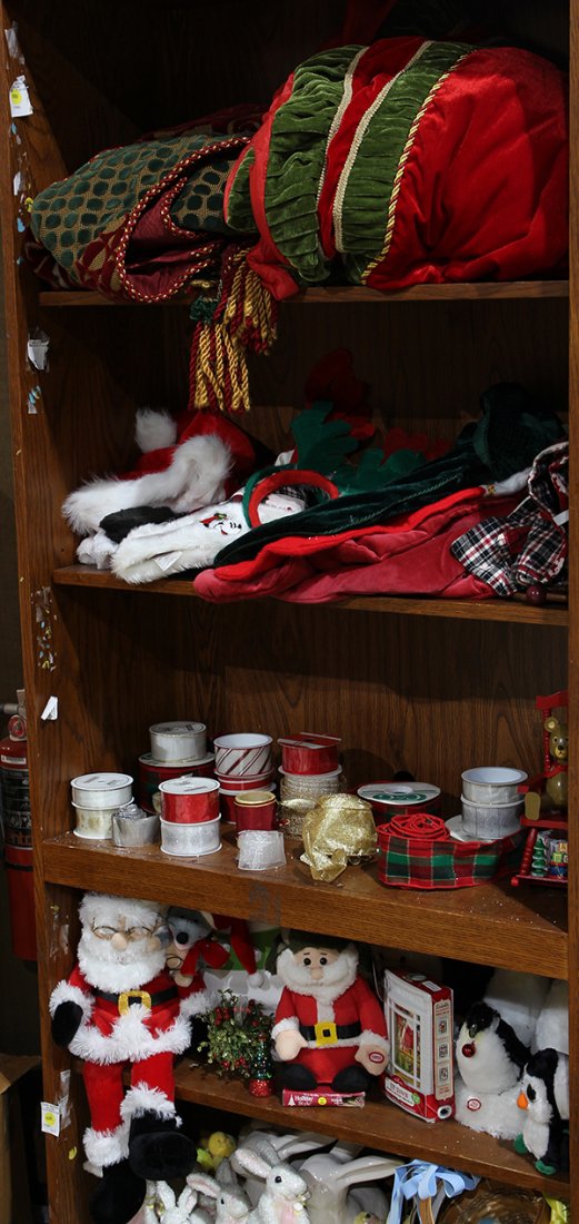 (lot of approx: (lot of approx. 40) Group of Christmas decorations including a tree skirt in green and red; Santa hats; ribbons, and plush Santas and penguins; together with Easter decorations including bunnies and c