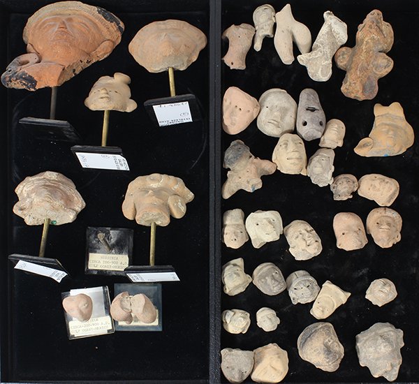 Pre-Columbian clay head fragments including some: (lot of 38) Pre-Columbian clay head fragments including some torsos, and a whistle, mostly form Eastern and Central Mexico, including the Huasteca culture, seven mounted to stands, largest: 4"h