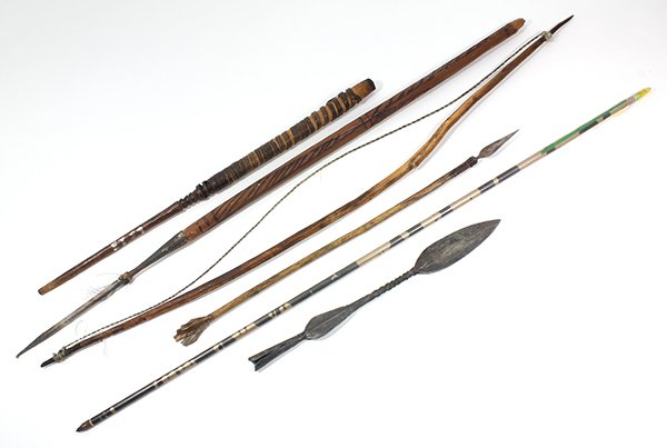 Ethnographic weapon group: (lot of 6) Ethnographic weapon group incluidng a bow, metal blade, wood shaft with spear tip, and a carved shaft mounted with a spear rod, largest: 32"l