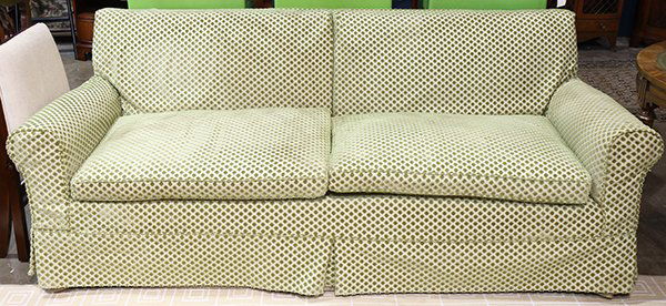 Moderne three seat sofa, having a square profile in: Moderne three seat sofa, having a square profile in green and red polka dots on a taupe ground, 32"h x 80"w x 23.5"h. Provenance: From the Nantucket, MA estate of Richard Mellon Scaife