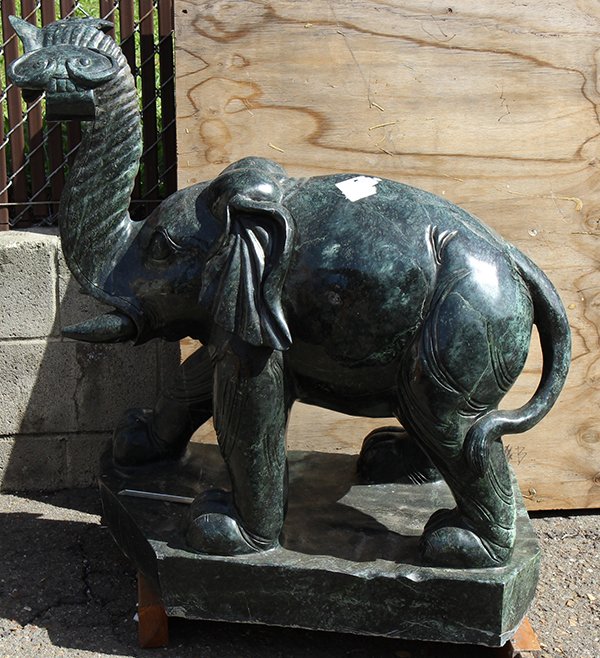 Standing elephant sculpture in the Chinese taste: Standing elephant sculpture in the Chinese taste, executed in green hard stone with a raised trunk holding a ruyi scepter and resting on a rectangular base, 39"h x 32'w x 16"d