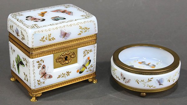 (lot of 2) English style milk glass table articles: (lot of 2) English style milk glass table articles, consisting of a small tray, and a jewelry box, each decorated with painted butterflies, and rising on a footed base, the box accented with scrolled 