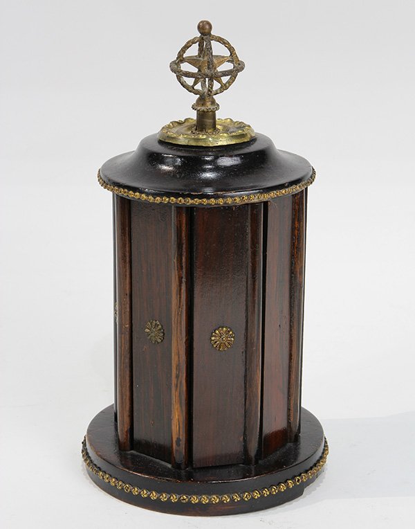 French ebonized and gilt metal mounted revolving cigar: French ebonized and gilt metal mounted revolving cigar holder, executed in rosewood and fruitwood, the cylidrical case having hinged doors, and rising on a circular base with a beaded border, 10"h. Pr