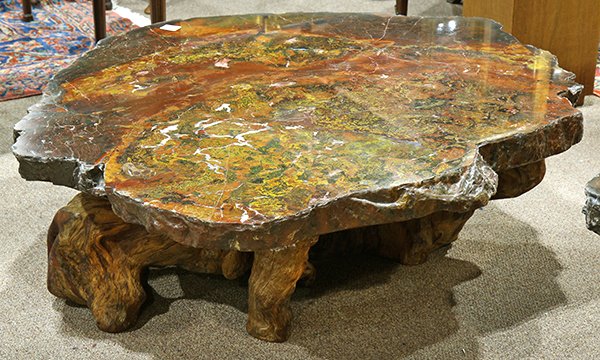 Mid Century petrified wood coffee table: Mid Century petrified wood coffee table, having a shaped slab top, and rising on a naturalistic base, 19"h x 54"w x 44"d
