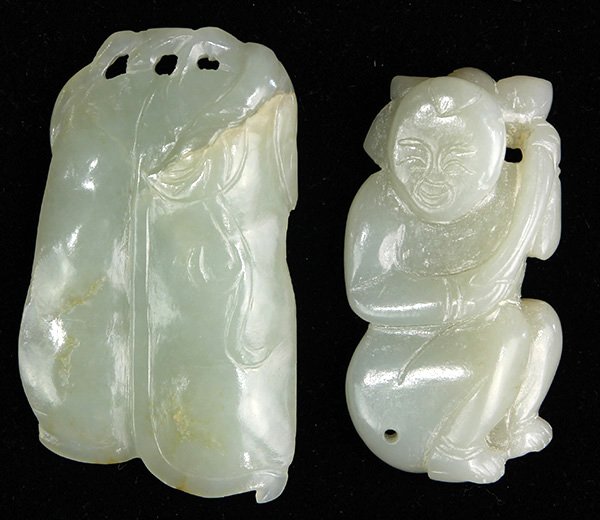 Two Chinese Jade Toggles: (lot of 2) Chinese celadon jade toggles, one of a child carrying a lotus sprig; another of two pea pods, largest: 2.5"h; Provenance: collection of Mrs. Ellen Sutton, Incline Village, Nevada