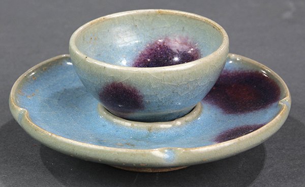 Chinese Jun Ware Cup and Stand, Ming dynasty: Chinese Jun type cup and stand, Ming dynasty, the shallow cup set above the floral form stand, overall covered in a light blue glaze with purple splashes to both interior and exterior, 4.25"dia