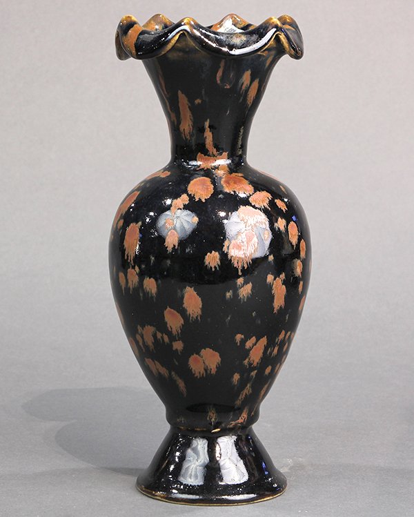 Chinese Iron Spot Dark Glazed Vase: Chinese iron spot black glazed ceramic vase, the trumpet neck flares to a prominent foliate rim, with light brown splashes over the black ground to exterior, 10"h