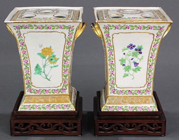 Two Chinese Export Bough Pots: (lot of 2) Chinese export porcelain bough pots, decorated with reserves of flowers, the sides with gilt handles above a monogram EL and a floral border on a mold woven ground, the rectangular lid with