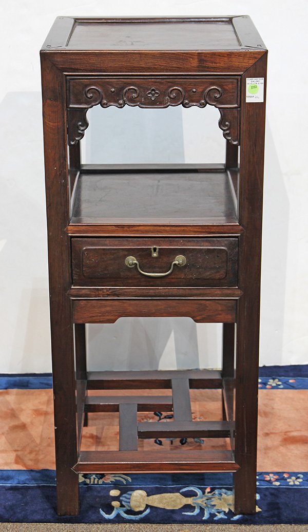 Chinese Tiered Side Table: Chinese hardwood tiered square side table, the apron carved with scrolls in relief below the upper tier, the second tier with a drawer, raised on straight supports joined to an open work base stretche