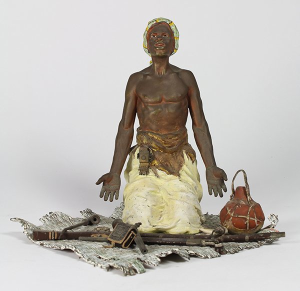 Franz Xavier Bergman (Austrian: Franz Xavier Bergman (Austrian, 1861-1936) cold-painted bronze figural group, depicting an Arab at prayer, with weapons at his side, kneeling on a carpet base, the back marked "Geschutzt" and numbered