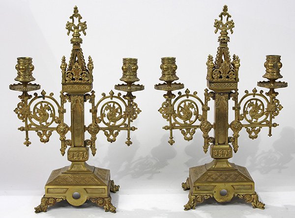 Pair of Gothic Revival bronze candelabra: Pair of Gothic Revival bronze candelabra, late 19th century, having two lights, the central support flanked with winged griffin medallions, and rising on a footed base, 16"h
