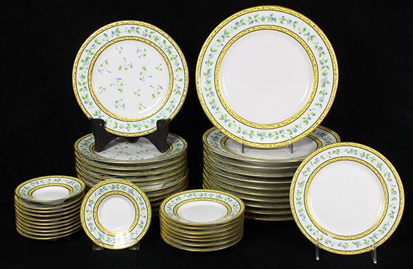 Raynaud Limoges, France partial table service,: Raynaud Limoges, France partial table service, decorated with a yellow rim, and polychrome floral border, consisting of (11) dinner plates, 10.5"dia.; (12) salad plates; (1) petit-four plate; (7) brea