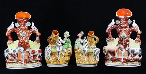 (lot of 4) Staffordshire figural spill vases,: (lot of 4) Staffordshire figural spill vases, comprising a pair of pearlware vases having a girl sitting next to a zebra having a basket of flowers on its back, 6.25"h x 4'w x 2.5"d; together with a p