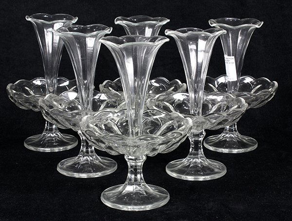 (lot of 6) Clear glass epergnes, each having a trumpet: (lot of 6) Clear glass epergnes, each having a trumpet form, above a scalloped lower tier, and rising on a conforming base, 8.5"h. Provenance: From the Ligonier, PA estate of Richard Mellon Scaife