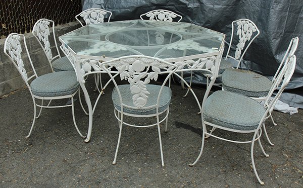 (lot of 6) Mid Century Wrought iron patio suite by: (lot of 6) Mid Century Wrought iron patio suite by Woodard, executed in the 'Pomegranate' pattern, each having a white paint decorated surface with pomegranate sprays, consisting of an octagonal table