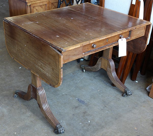 Regency mahogany drop leaf table, early 19th century,: Regency mahogany drop leaf table, early 19th century, having a rectangular top with shaped drops, and rising on outswept reeded legs, ending in paw capped brass feet, terminating on casters, 28"h x 34