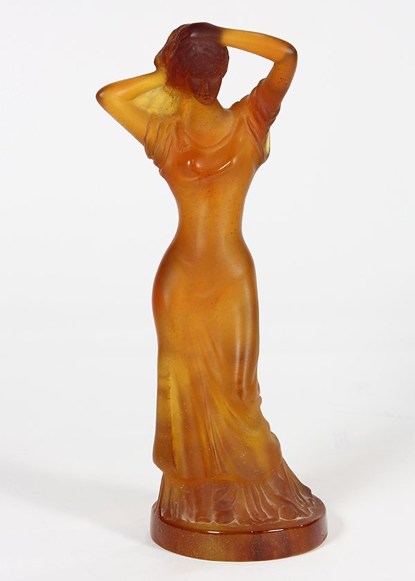Daum France figure of a beauty: Daum France figure of a beauty, in the Art Nouveau taste, executed in amber pate de verre, the lady stands with her arms holding up her long hair and wears a draped dress, the whole rests on a circula