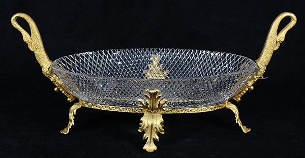 Louis XVI style crystal and ormolu mounted centerpiece: Louis XVI style crystal and ormolu mounted centerpiece attributed to Baccarat, having a diamond-cut oval form bowl, flanked with swan head handles, and rising on acanthus leaf supports, 12"h x 25"w. P